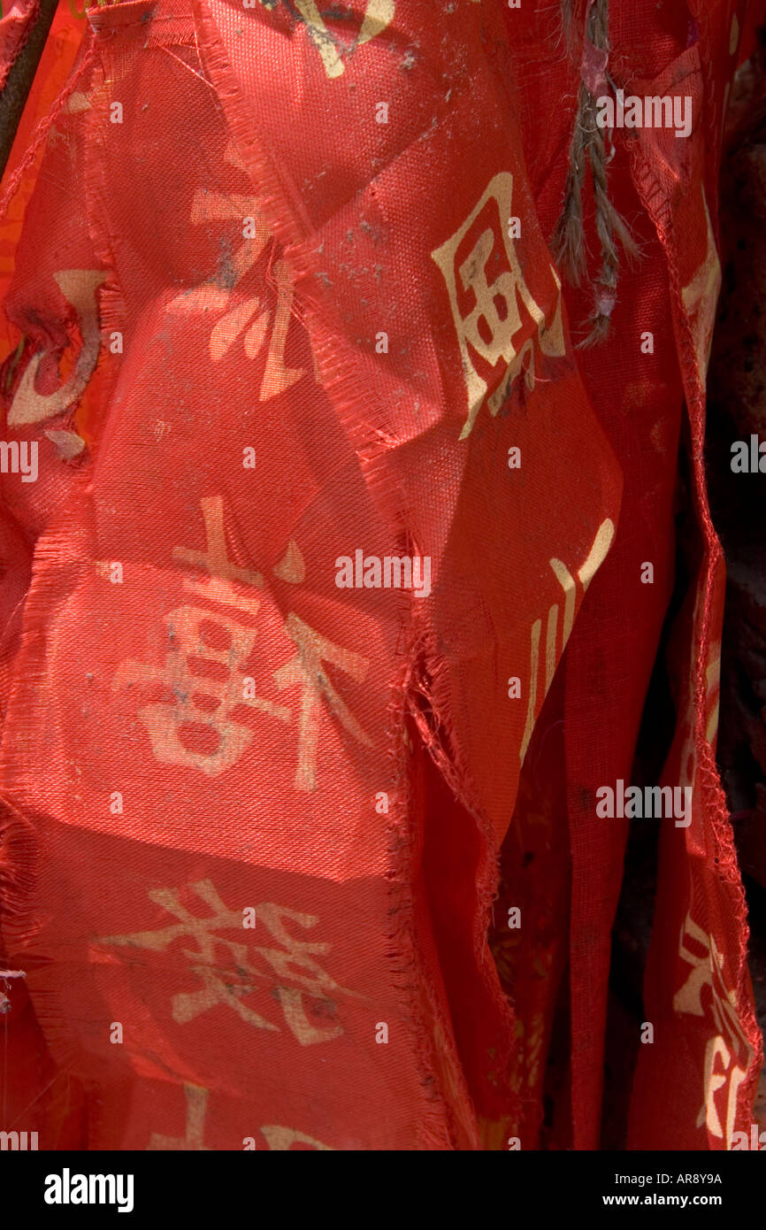 Fire cracker ribbon with chinese writing on in gold close up found at Wat Chalong Temple, Phuket, Thailand Stock Photo