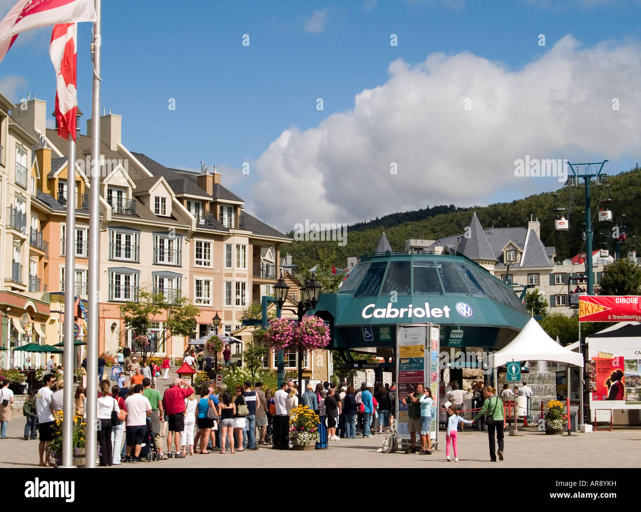 A line of people waiting to ride the cable car in the busy village of Mont Tremblant in the Laurentian Mountains, Quebec Canada Stock Photo