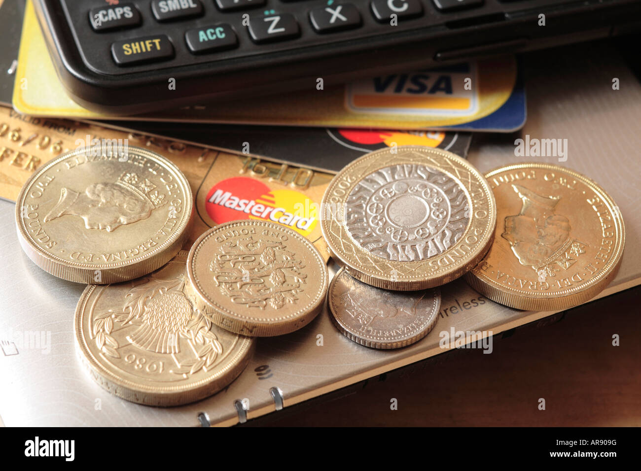 Pile of pound and two pound coins and small change, credit cards and