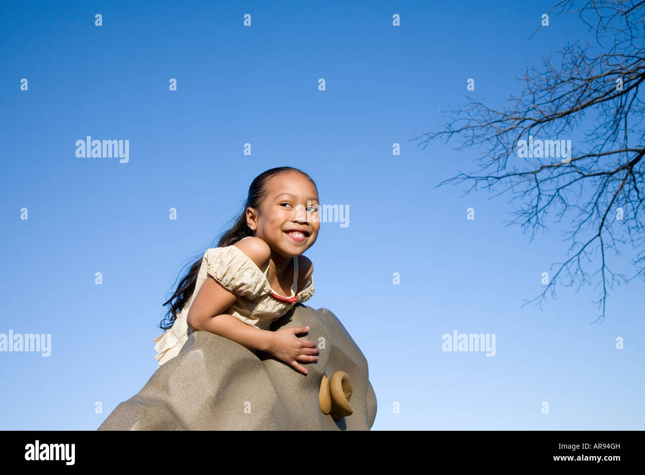 Young Asian girl at the top of a rock climbing wall Stock Photo - Alamy