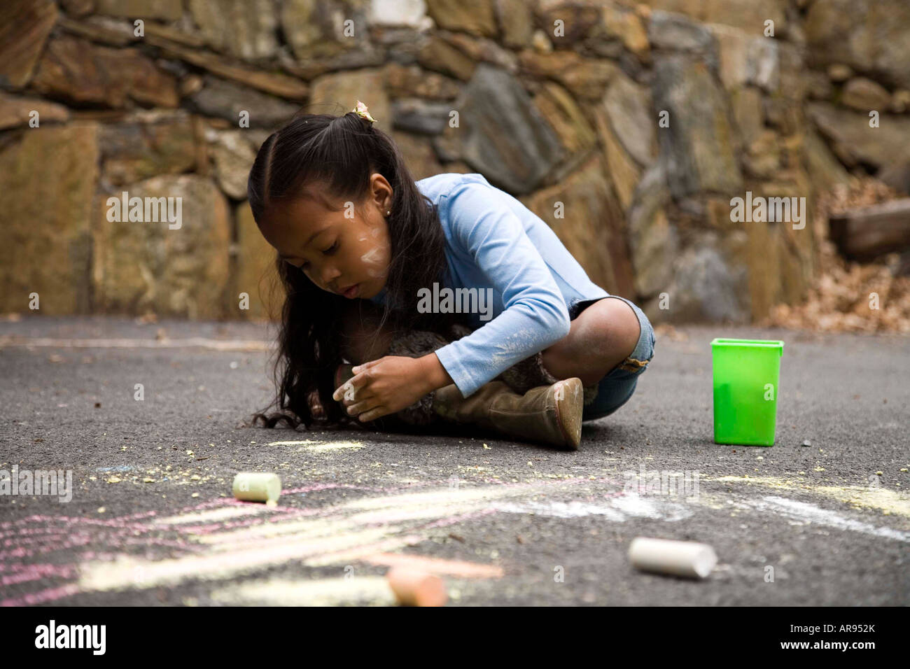 Young Asian girl drawing on pavement with chalk Stock Photo - Alamy