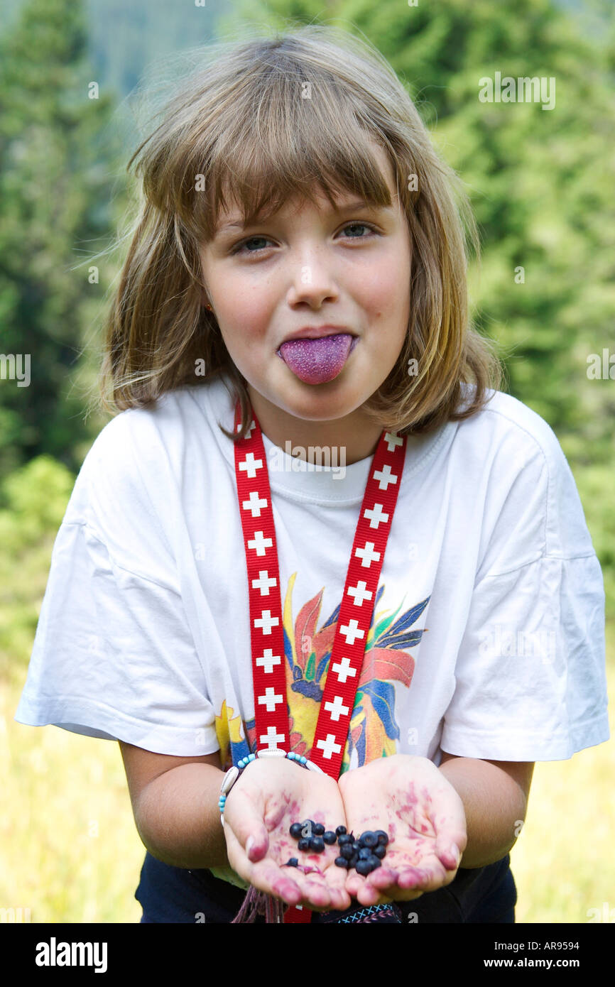 Eight years old girl with blueberries and blue tongue Stock Photo Alamy
