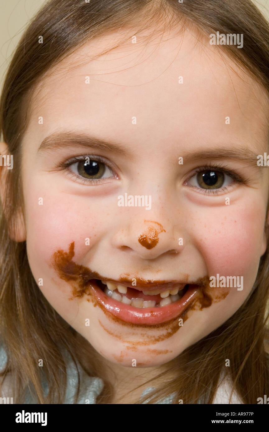Little girl's chocolate covered face after baking Stock Photo
