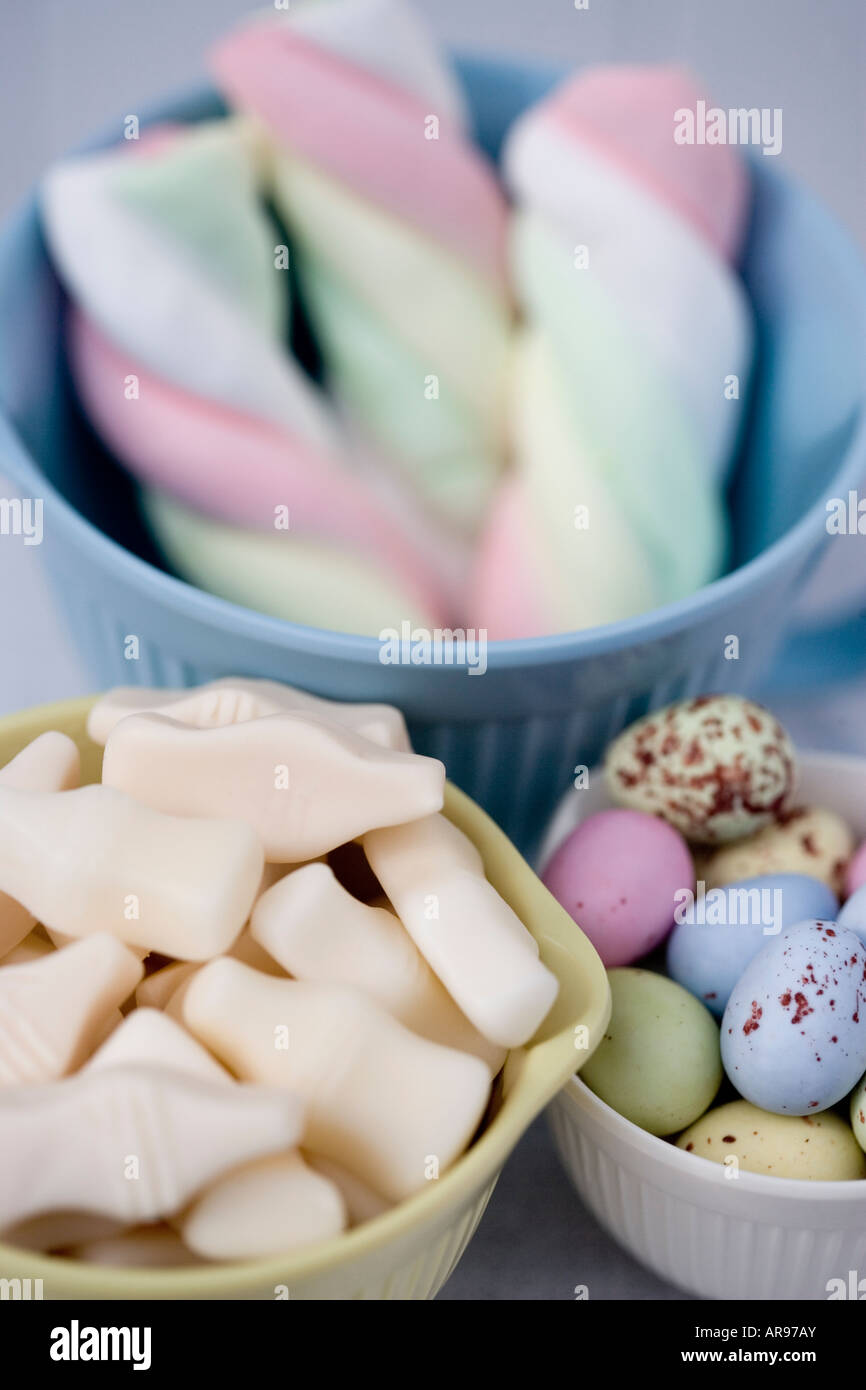 Assorted sweets in pastel vintage style bowls. Stock Photo