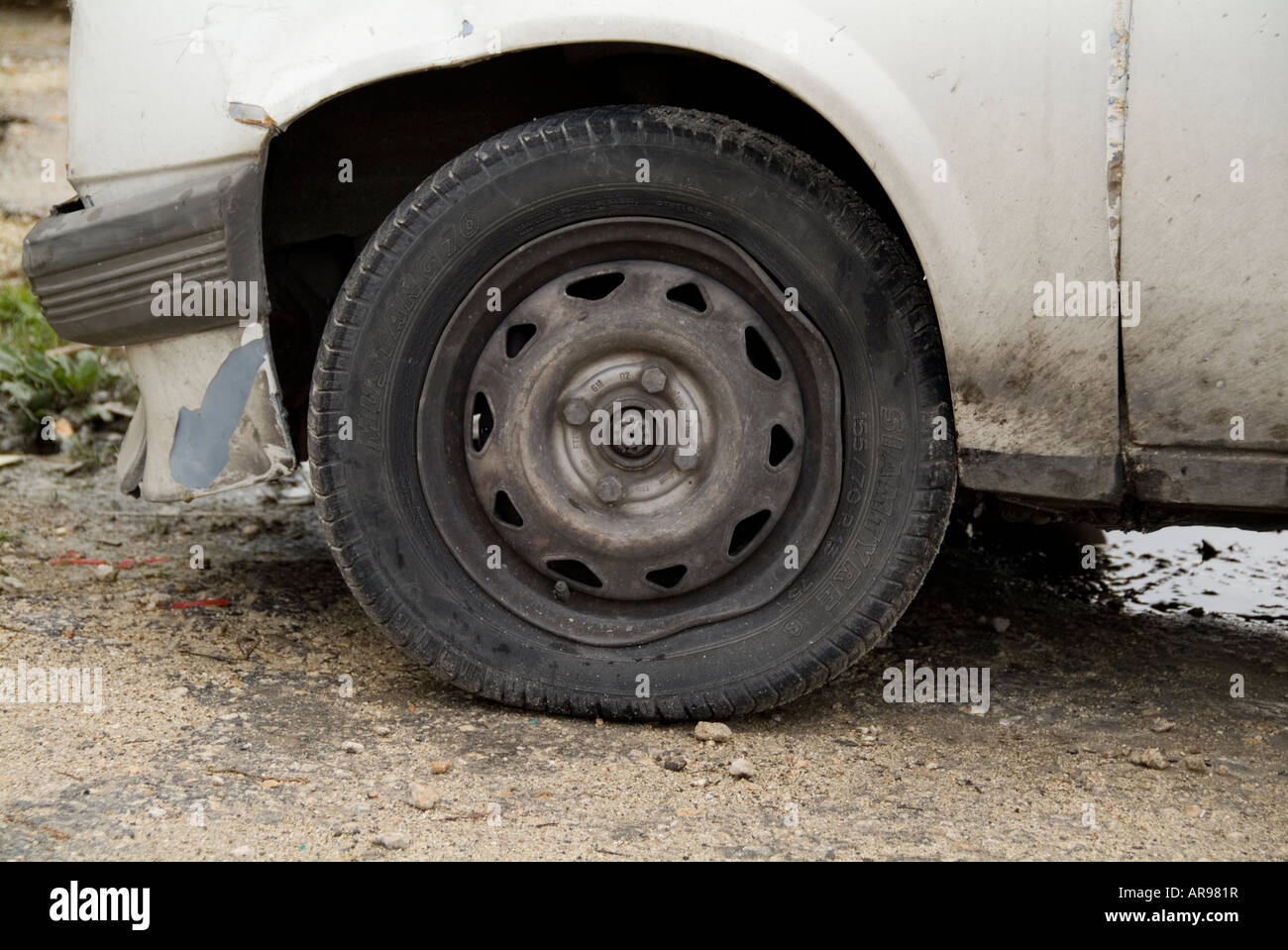 bent wheel rim car hit a pothole old car Stock Photo Alamy