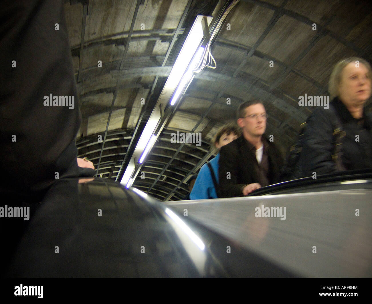 Passengers ascending an escalator on the London underground Stock Photo