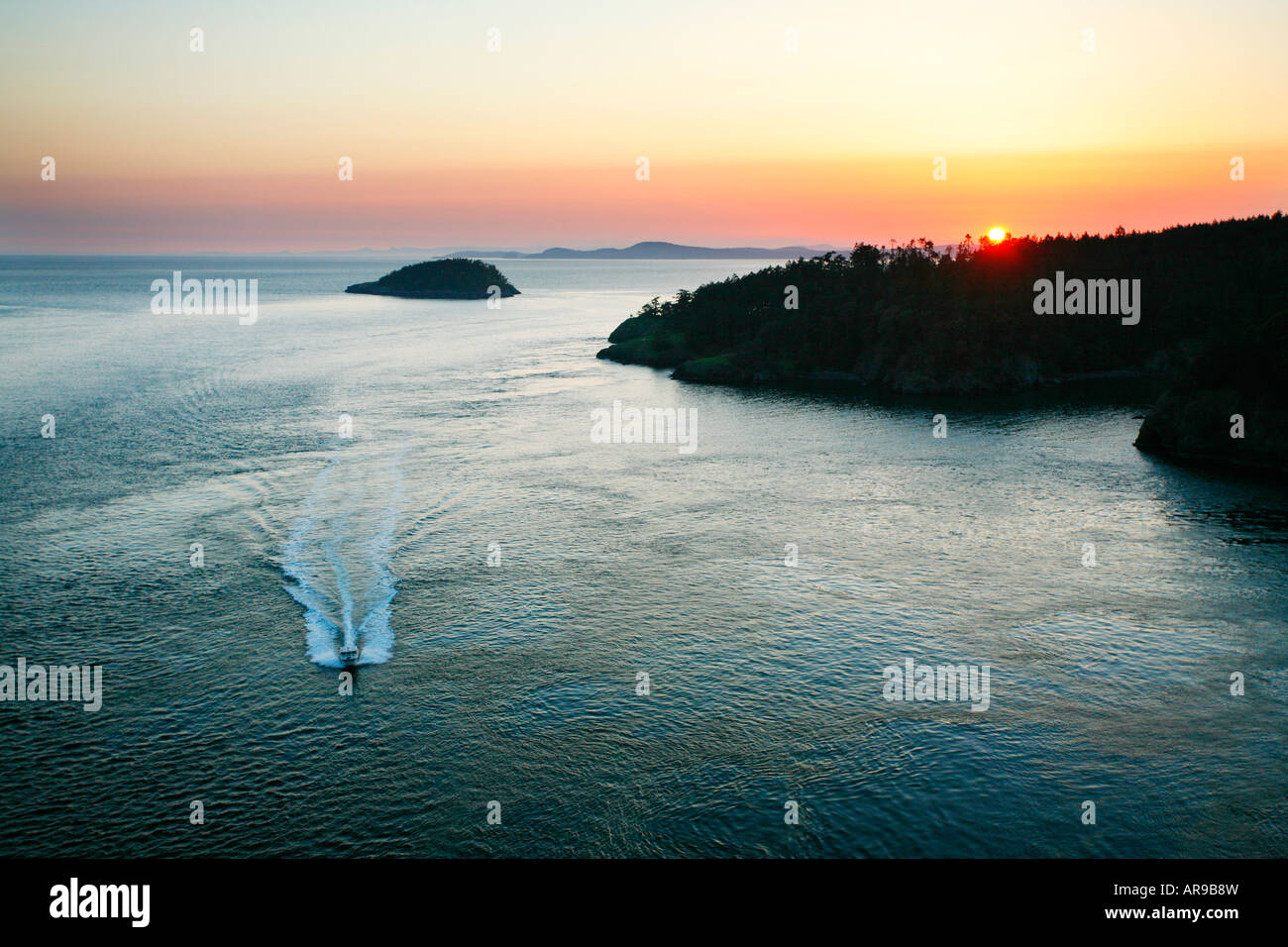 Sunset and power boat, Deception Pass, Whidbey Island, Washington State Stock Photo