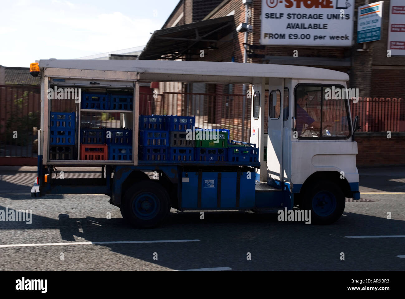 Image of a battery powered milk float delivering milk in the morning in Nottingham England Stock Photo