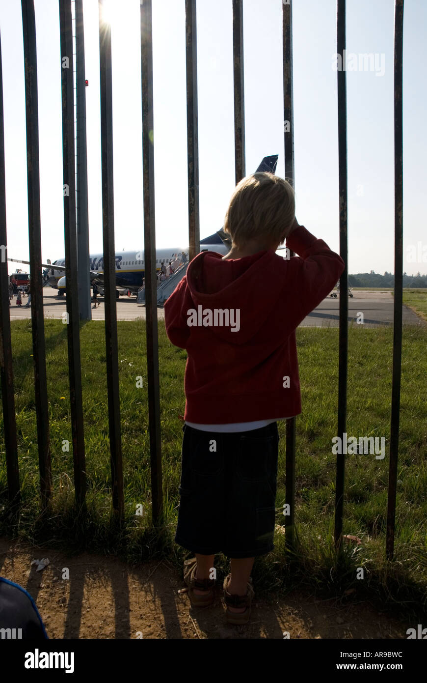 Image of a small boy saying goodbye to members of his family at the aeroport Stock Photo