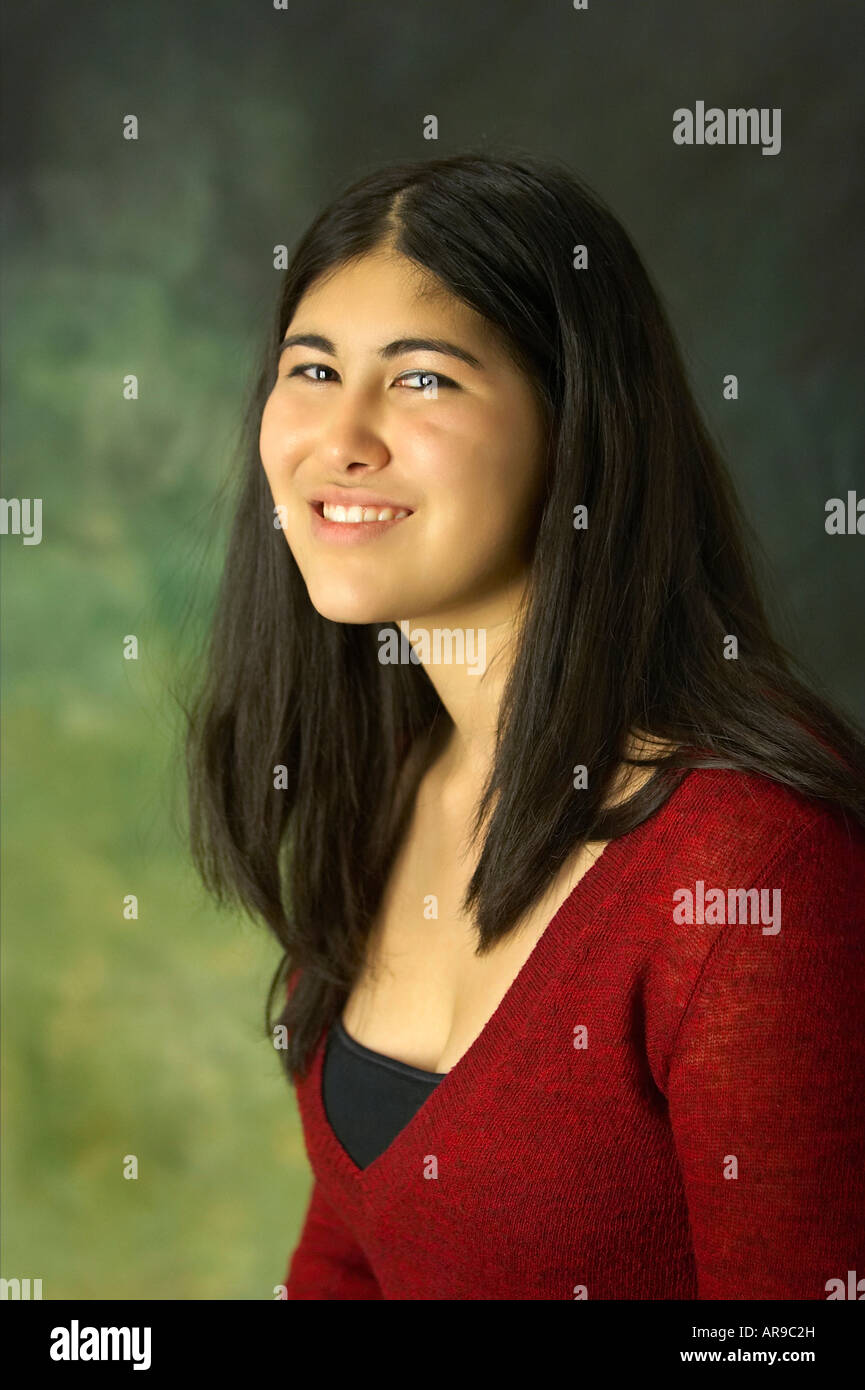 A young Korean American woman smiling at the camera head and shoulders shot Stock Photo