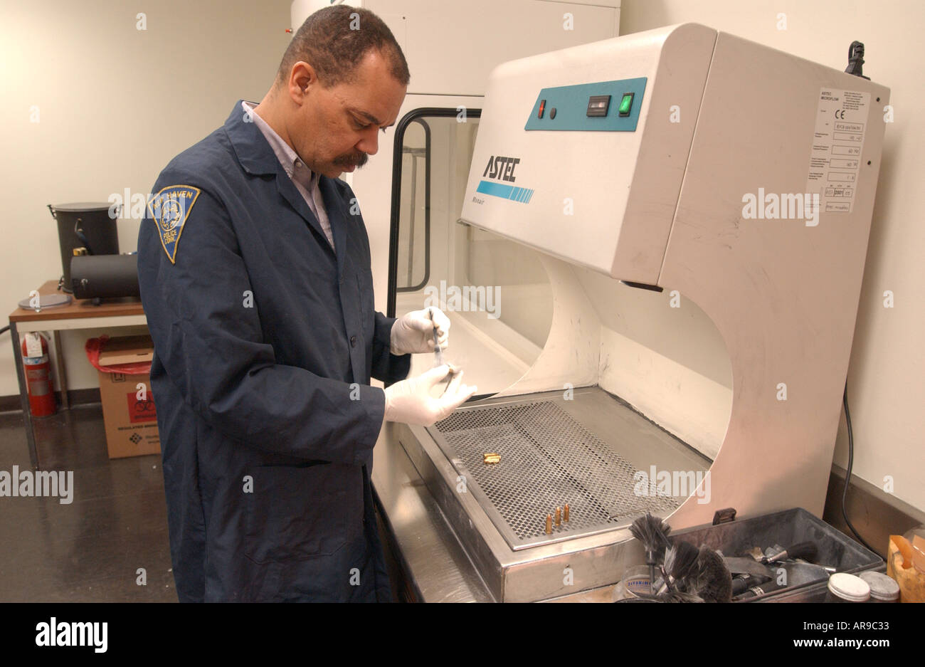 Police forensics examiner using technology to catch criminals Stock