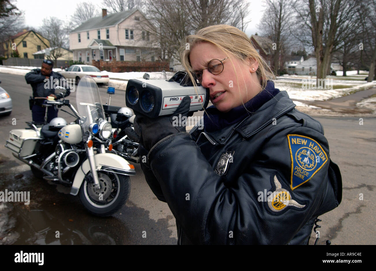 Police officer using a Radar gun at a speed trap in New Haven CT USA Stock Photo