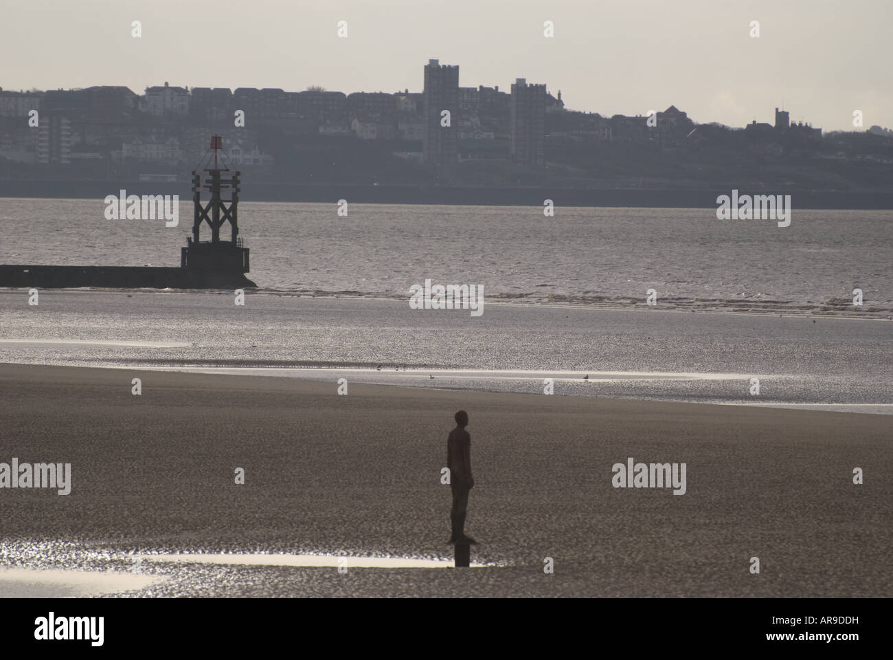 Statue and lighthouse on Crosby Beach, Merseyside, UK Stock Photo Alamy
