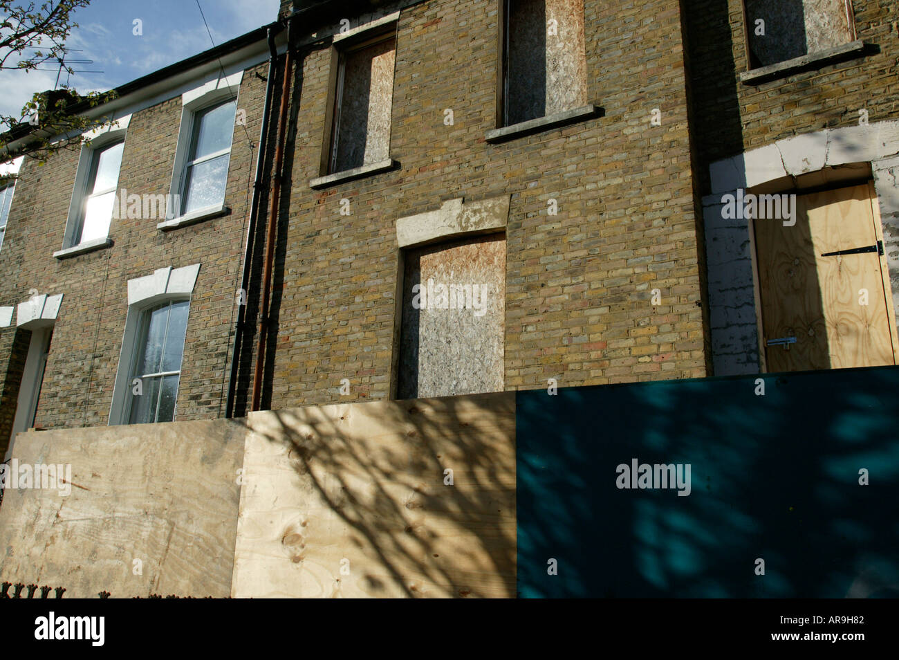 derelict boarded-up house in north london Stock Photo