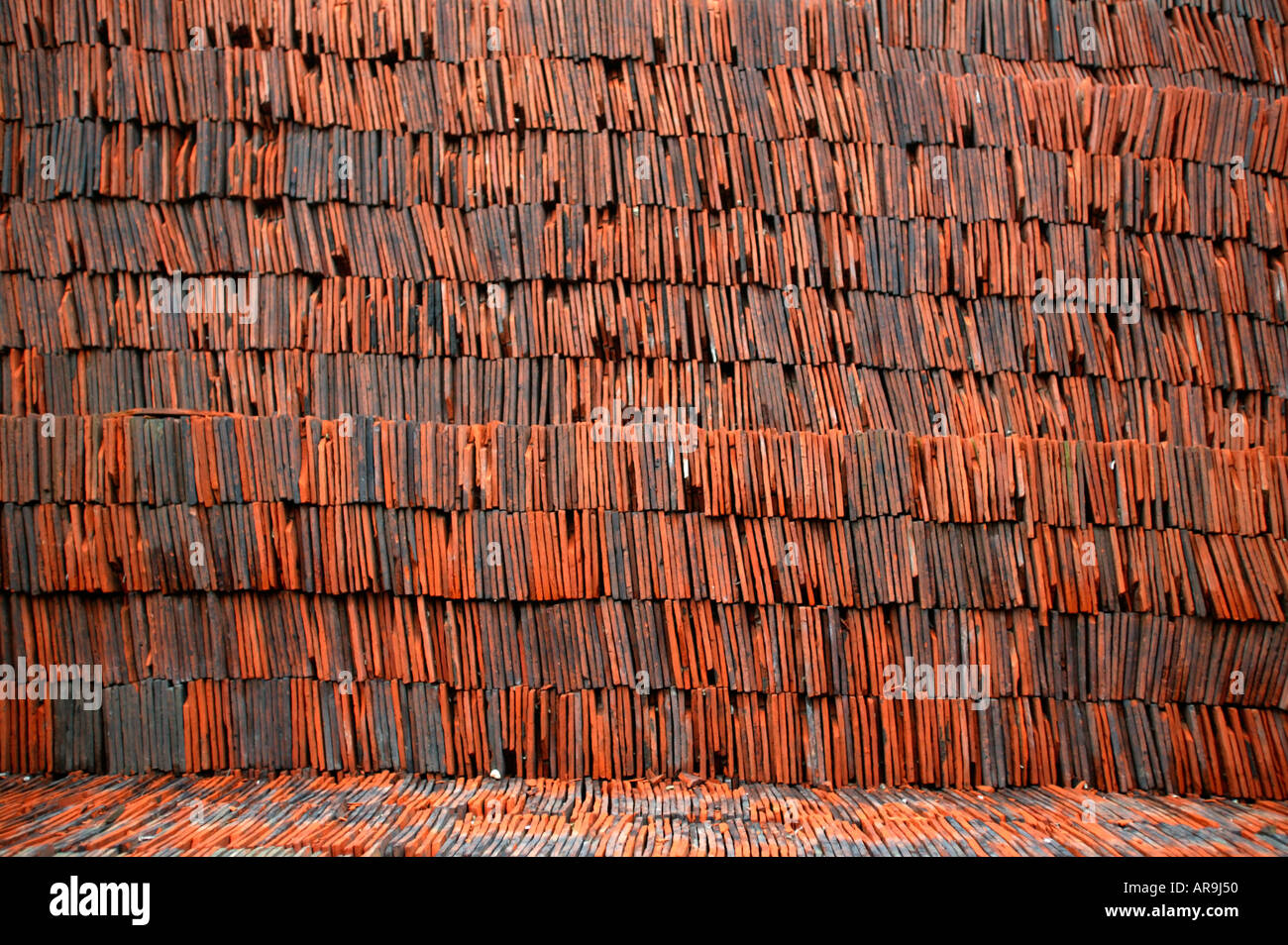 stack of terracotta roof tiles at solopark building supply yard Stock