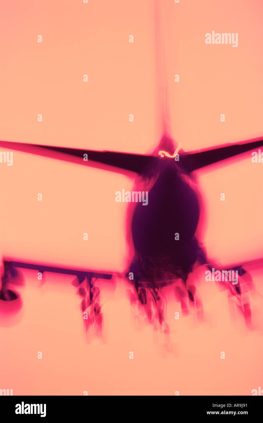 Boeing 747 jumbo jet abstract blurred effect purple pink colours undercarriage silhouette Stock Photo