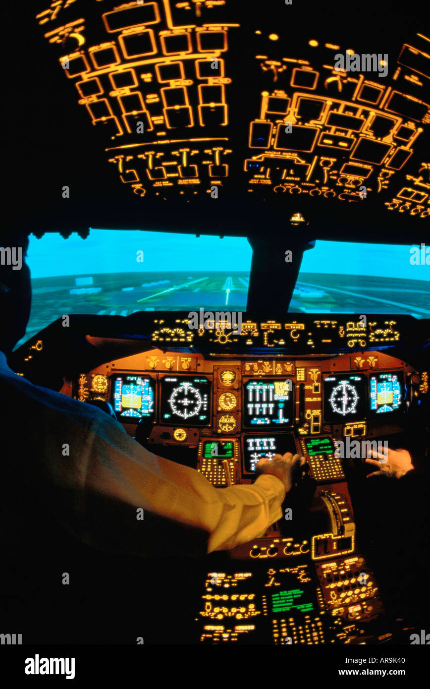 Boeing 747 jumbo jet pilots in the cockpit simulator on a runway ready for take off Stock Photo