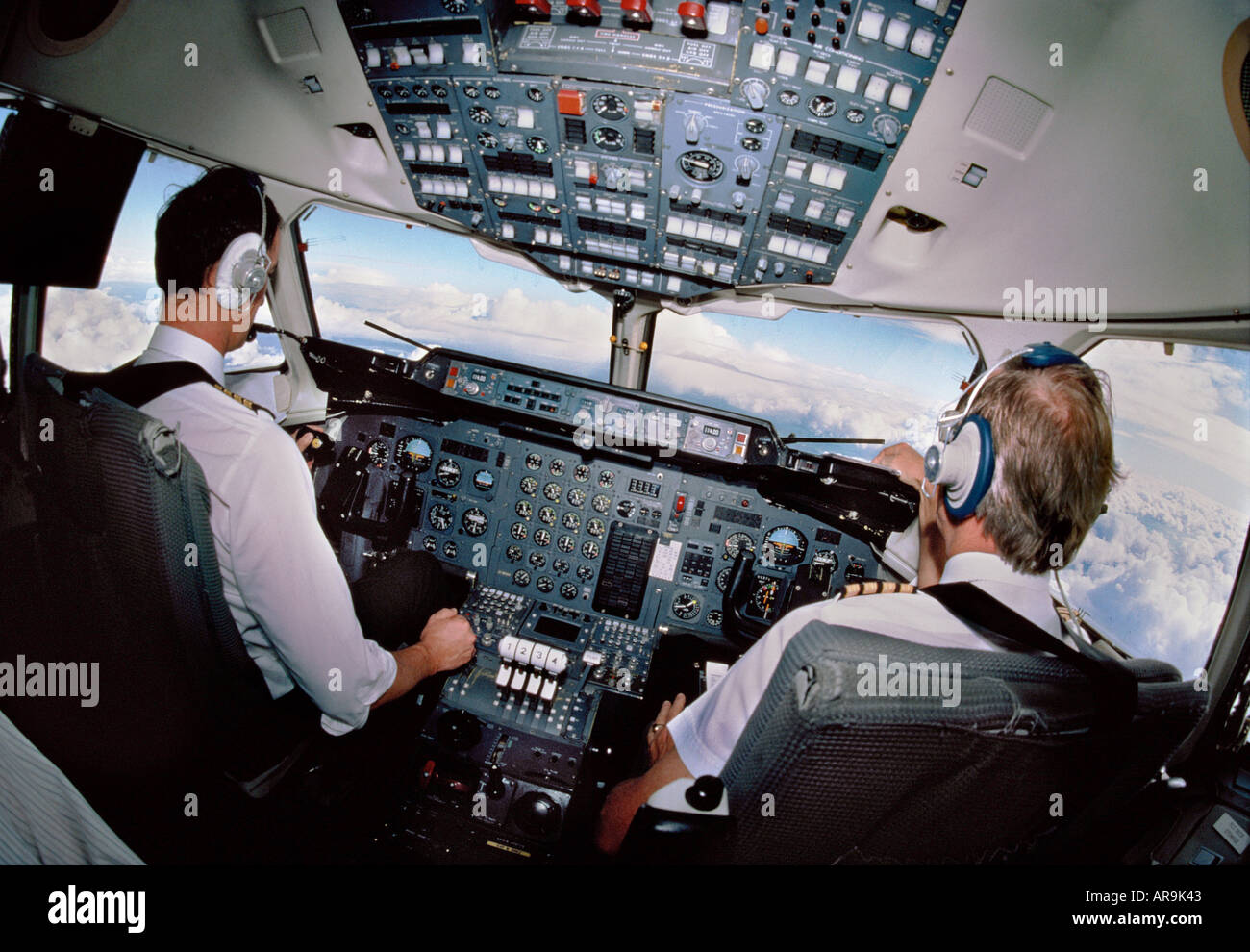 regional jet airliner pilots in cockpit at the avionics controls in a BAE 146 Stock Photo