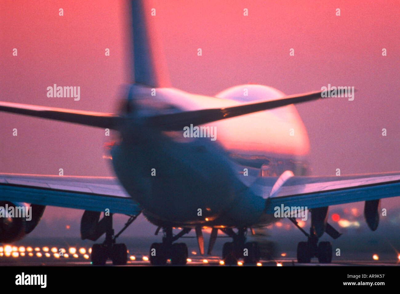 Boeing 747 jumbo jet taxiing past runway lights for take off Stock Photo