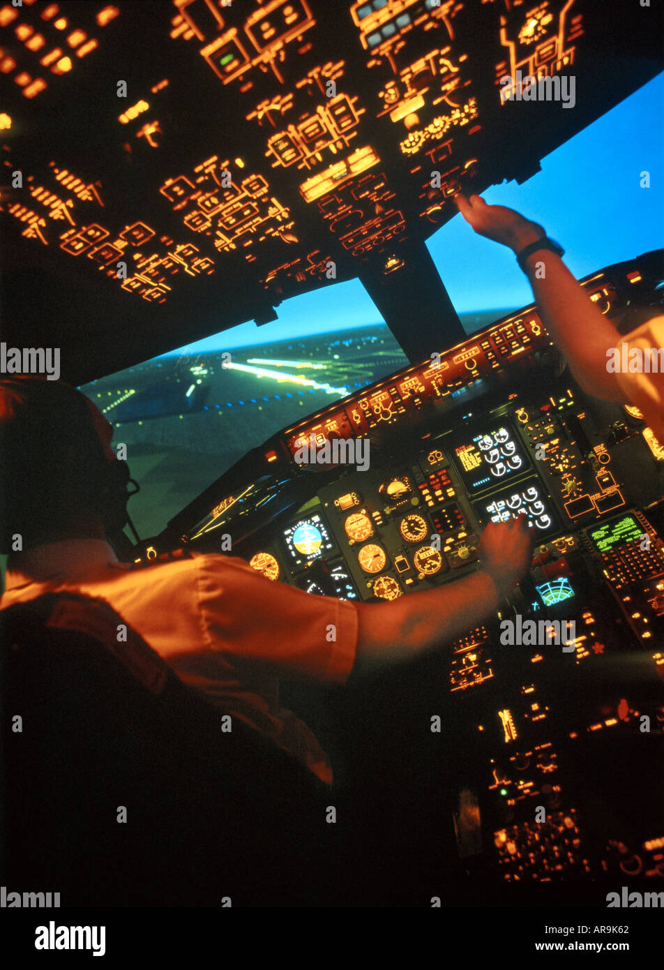 Boeing 757 jet airliner cockpit pilots at the controls on final approach to land with one engine failed Stock Photo