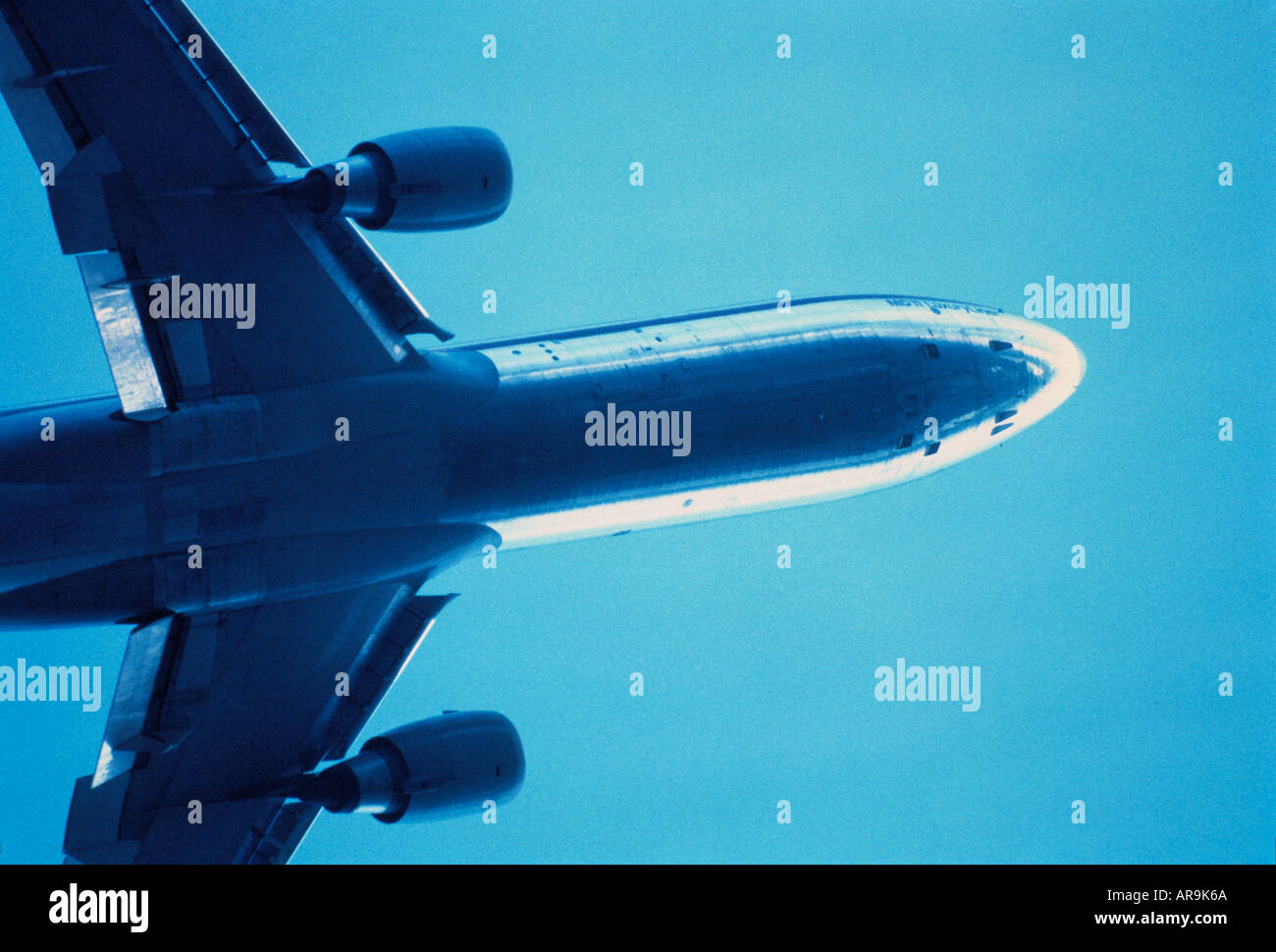 Boeing MD-11 jumbo jet airliner blue sky at cruising altitude aero engines wings Stock Photo