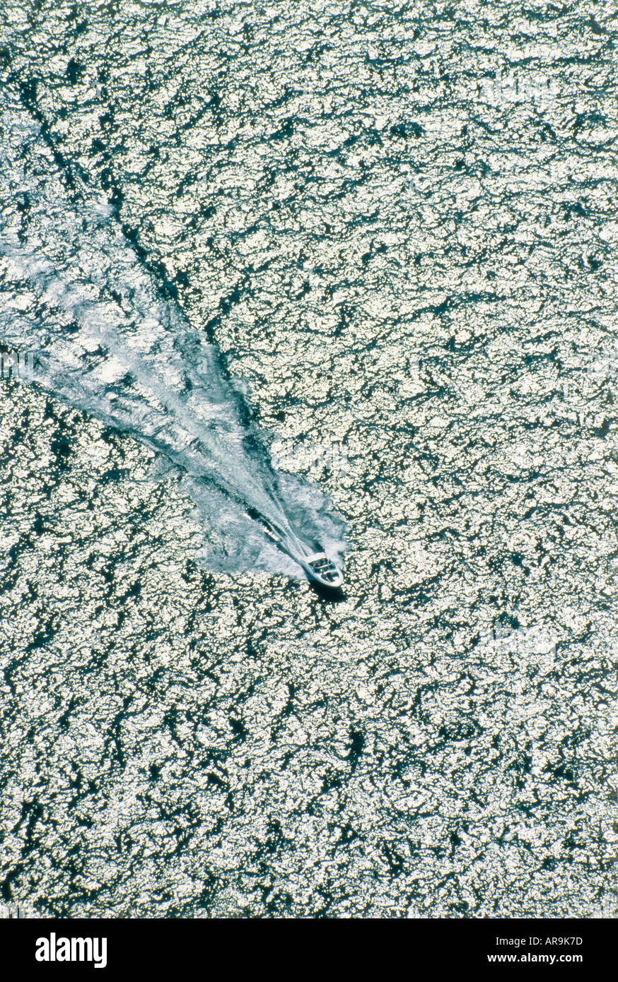 aerial view of speed boat on water sea lake with wake wave fanning out behind high speed aerial view from above Stock Photo