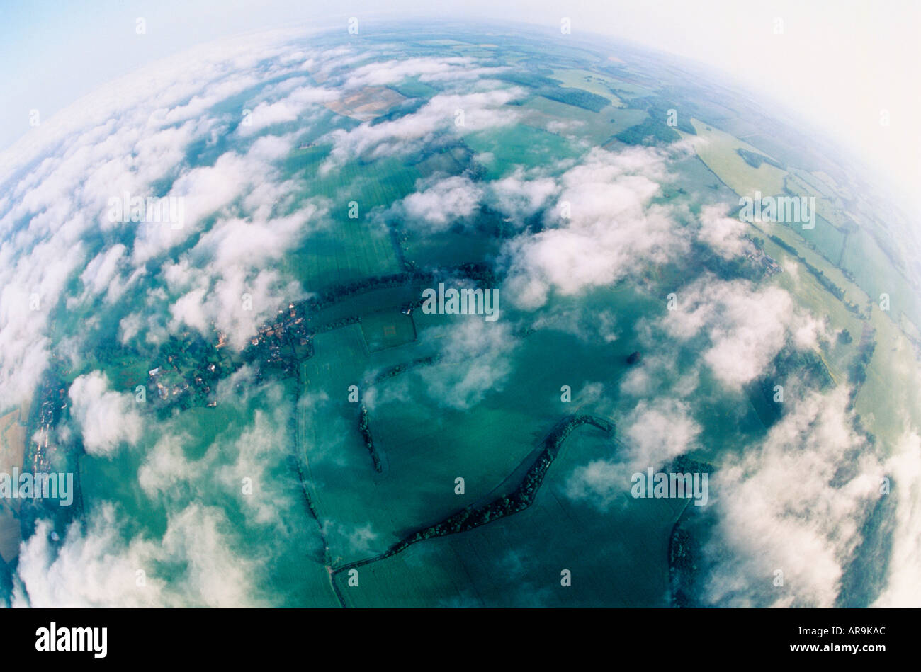 aerial view of green grassy agricultural fields dreamy  fisheye landscape and scattered strato cumulus clouds fisheye Stock Photo