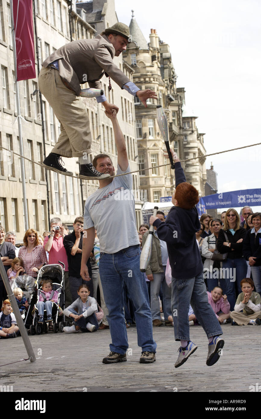 Tight Rope Walker with helpers Stock Photo - Alamy