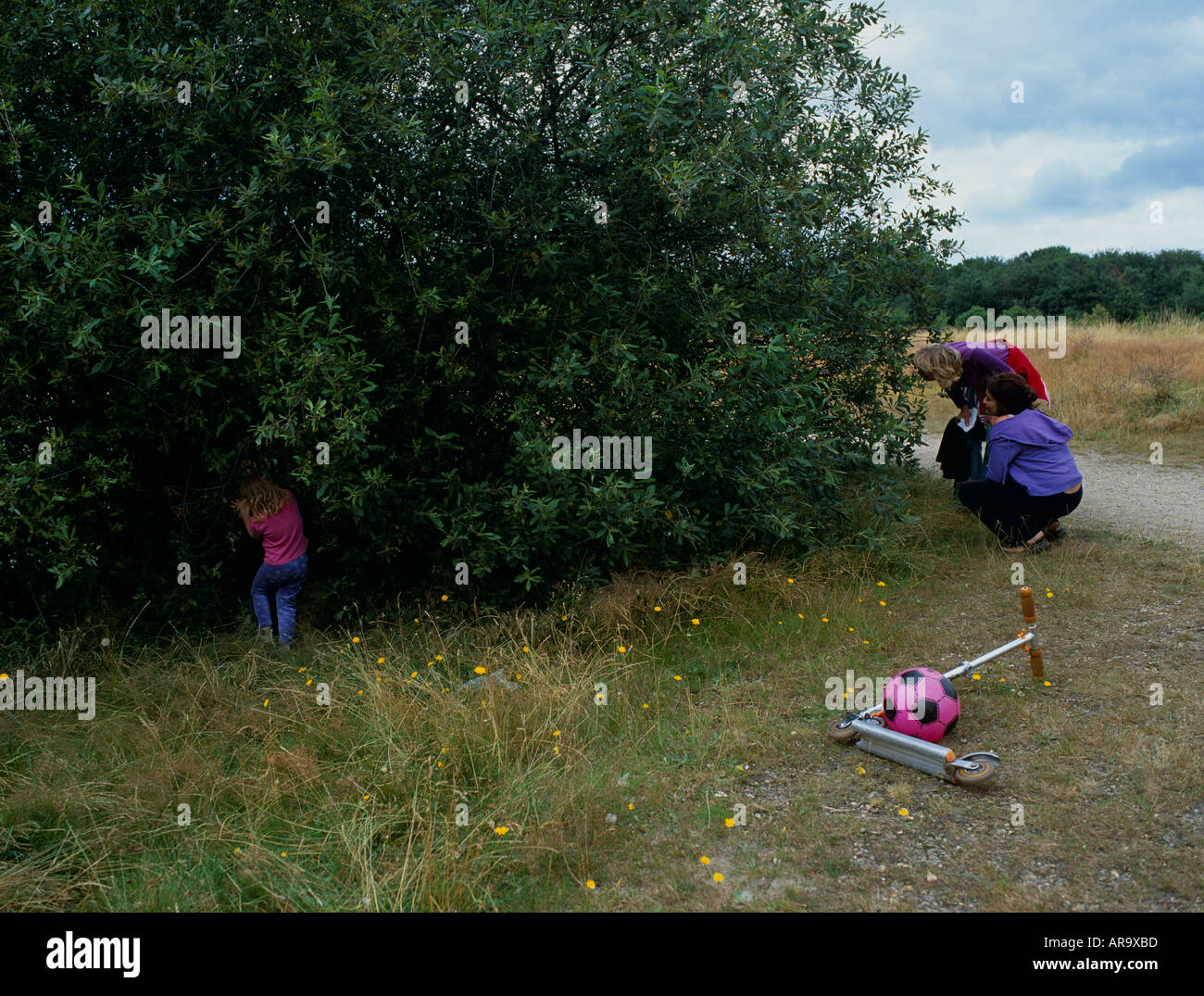Children playing 'Hide and Seek' Wanstead Flats, Epping Forest, London