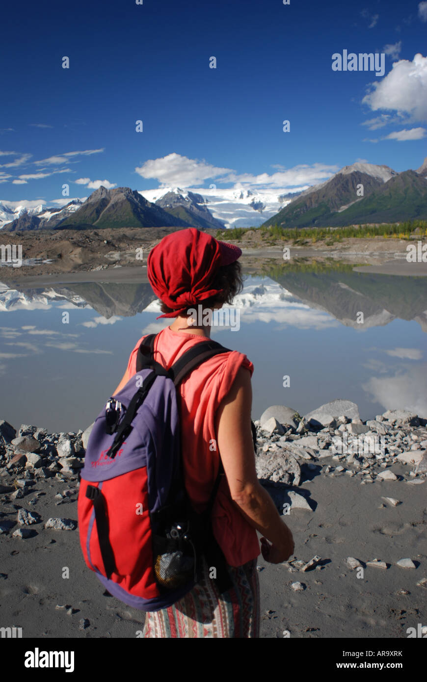 Hiker on foot of Kennicott glacier and glacial lake at McCarthy Wrangell Saint Elias National Park Alaska Stock Photo