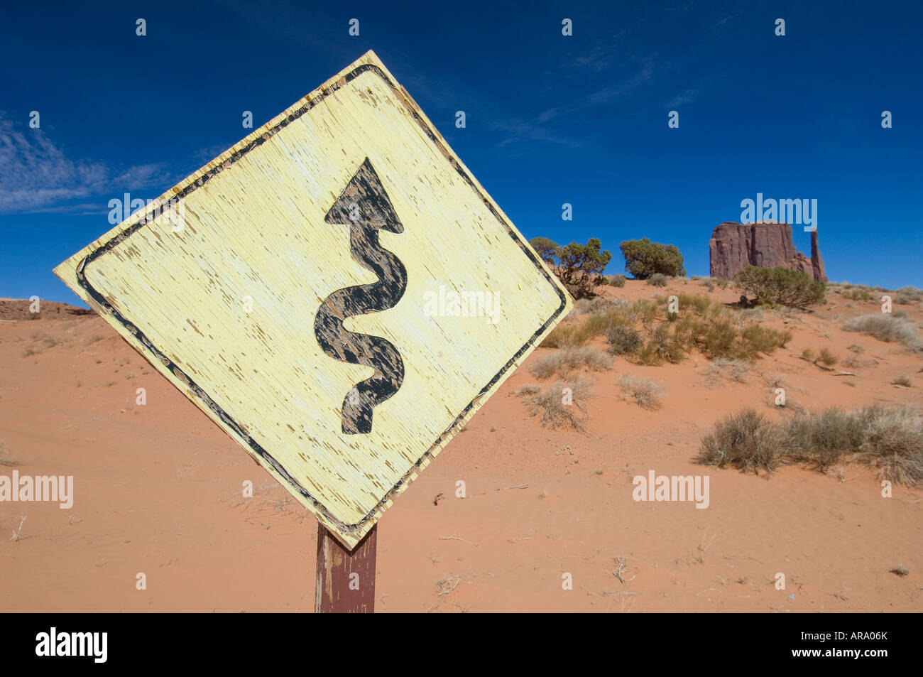 Mitten and bent road sign, Monument Valley navajo tribal park, USA Stock Photo