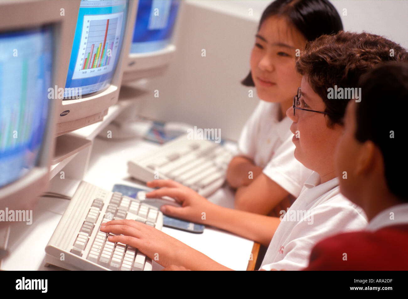 1990’s School Junior Computer Class Multiracial ethnic junior middle school students in 90's school computer class Stock Photo