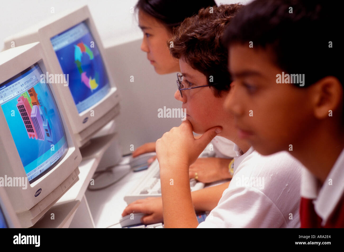 Multiracial junior middle school students in school computer class Stock Photo