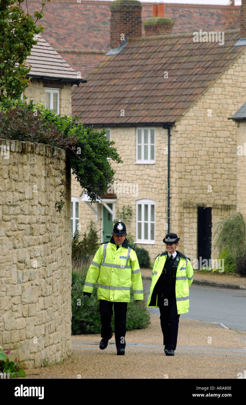 Police Officers patrol the streets of the Poundbury Estate in Dorset Britain UK Stock Photo