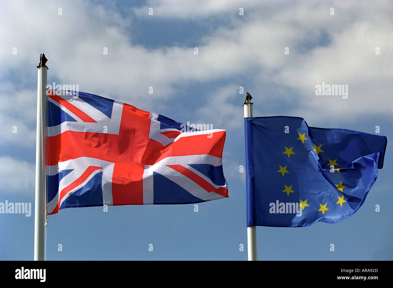 A United Kingdom flag flying next to a European Union flag Stock Photo
