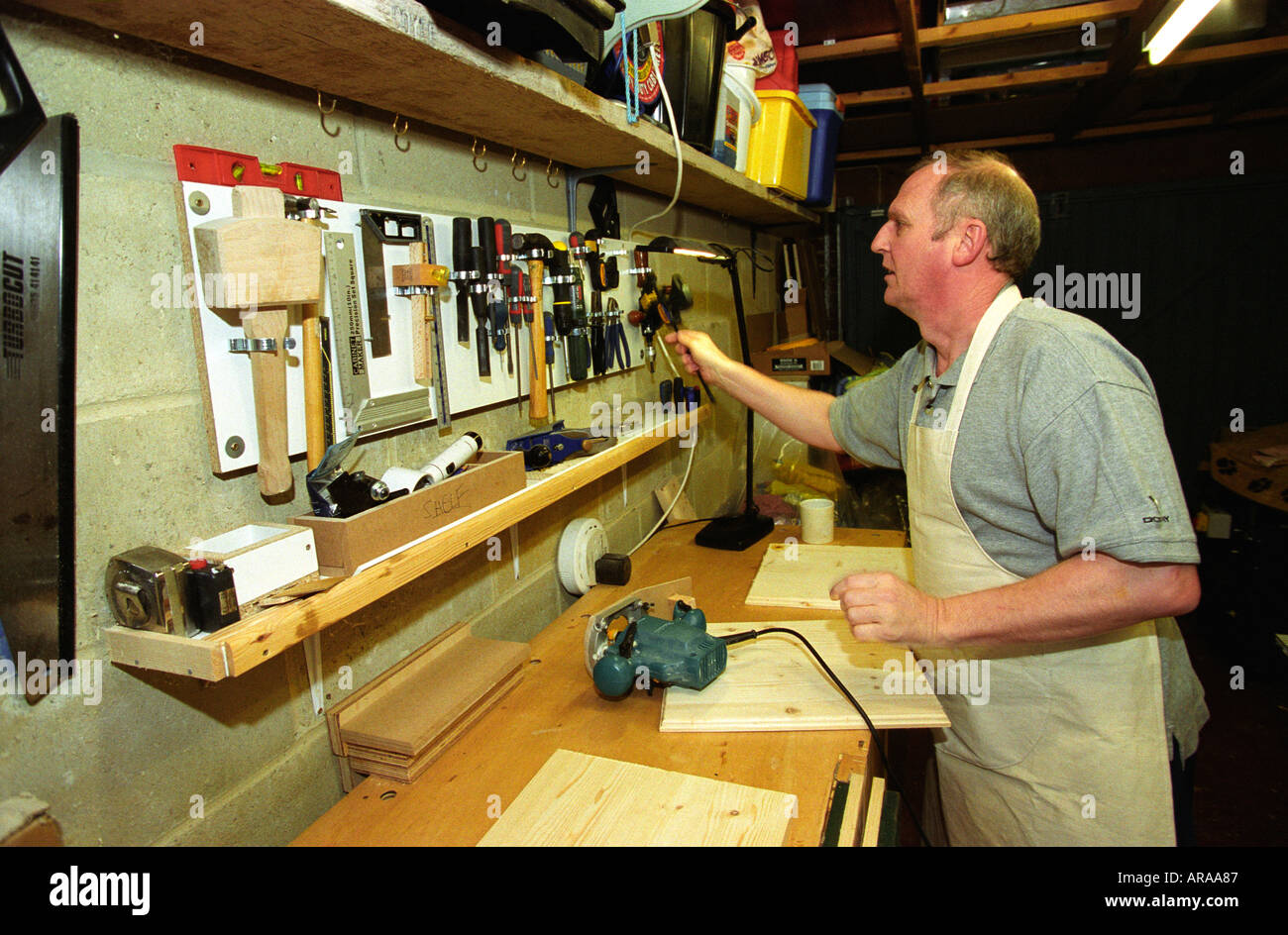 Visually impaired man undertaking DIY at home England Stock Photo