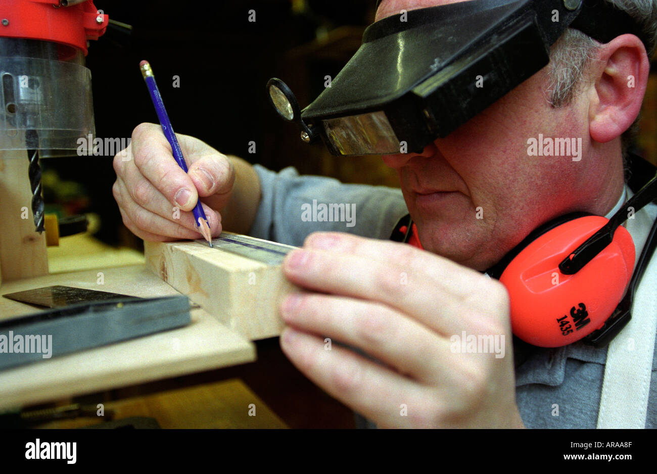 Visually impaired man undertaking DIY task at his home using custom