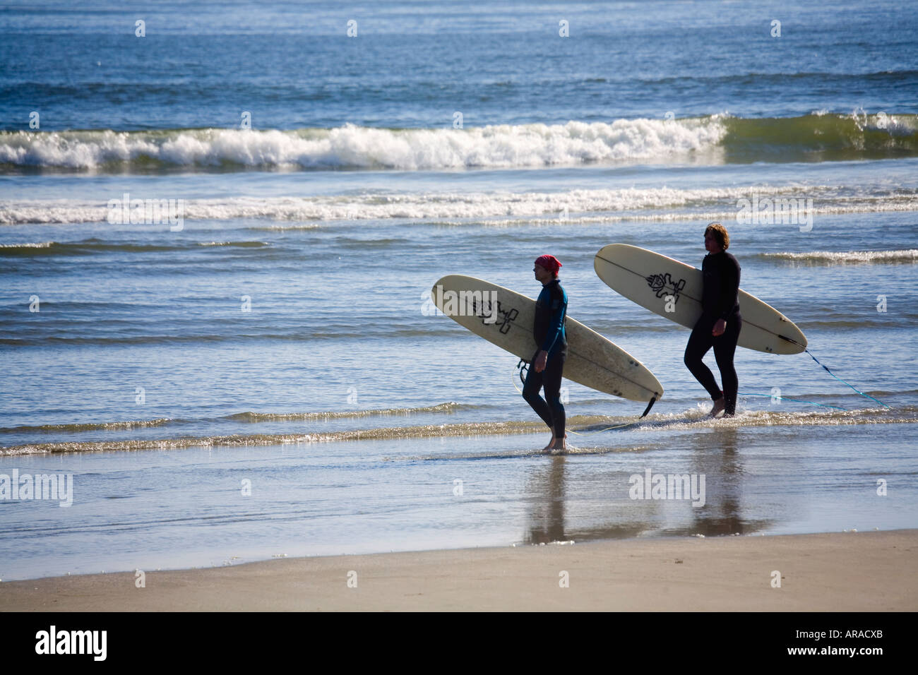 Two surfers on Long Beach Pacific Rim national park reserve Vancouver island Canada Stock Photo
