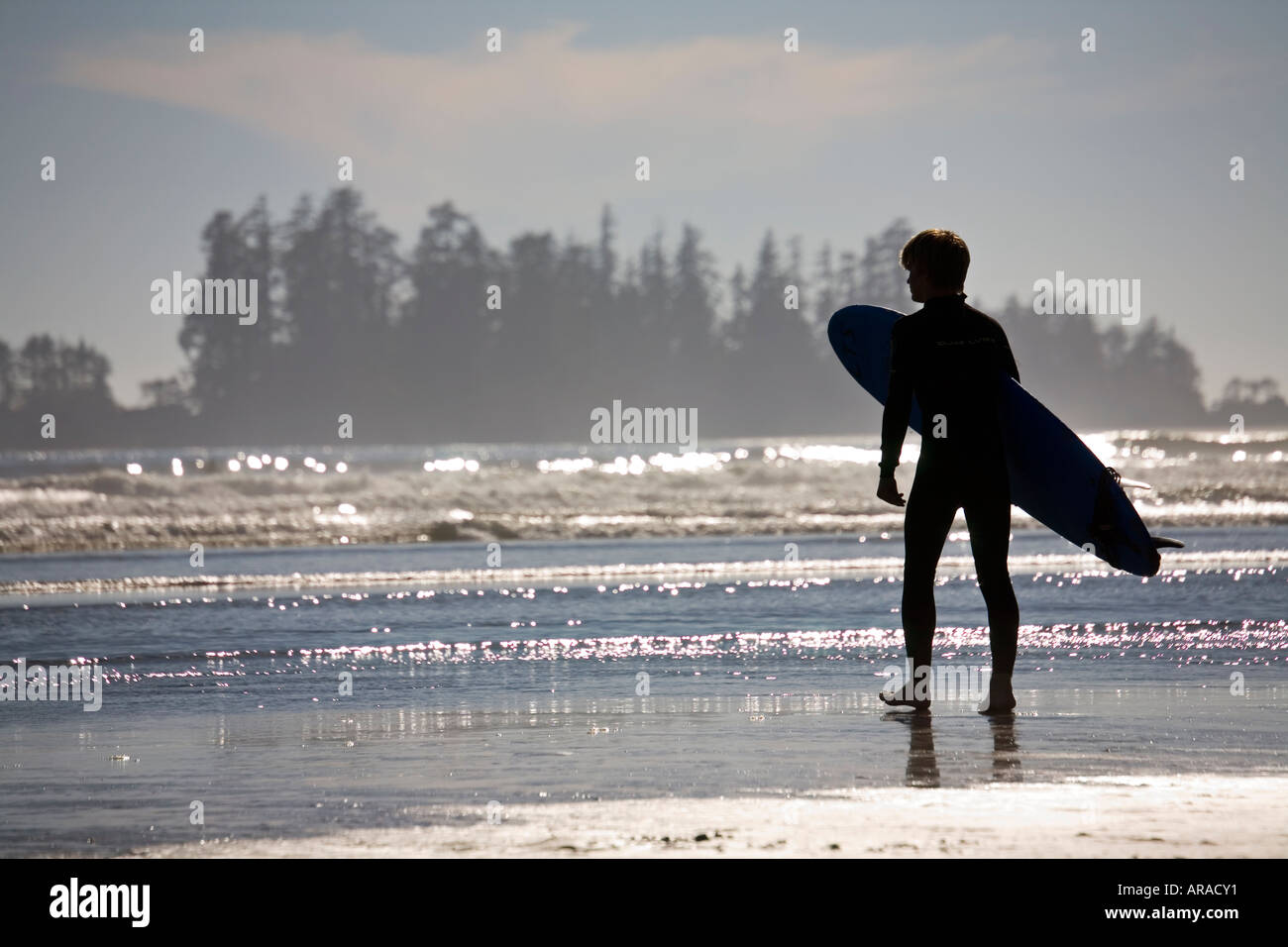 Surfer with board on Long Beach Pacific Rim national park reserve Vancouver island Canada Stock Photo