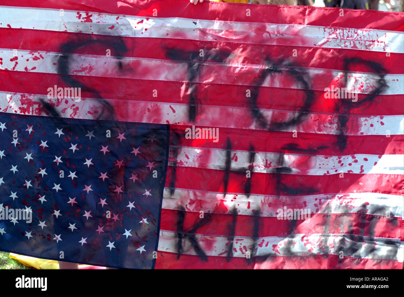 Upside down US flag Stop the Killing protesting Kosovo war. Heart of the Beast May Day Festival Minneapolis Minnesota MN USA Stock Photo