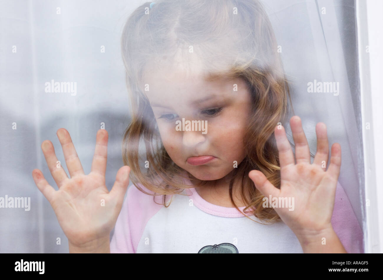 Sad Young Girl 57 Years With Hands Pressed Against Glass Wind