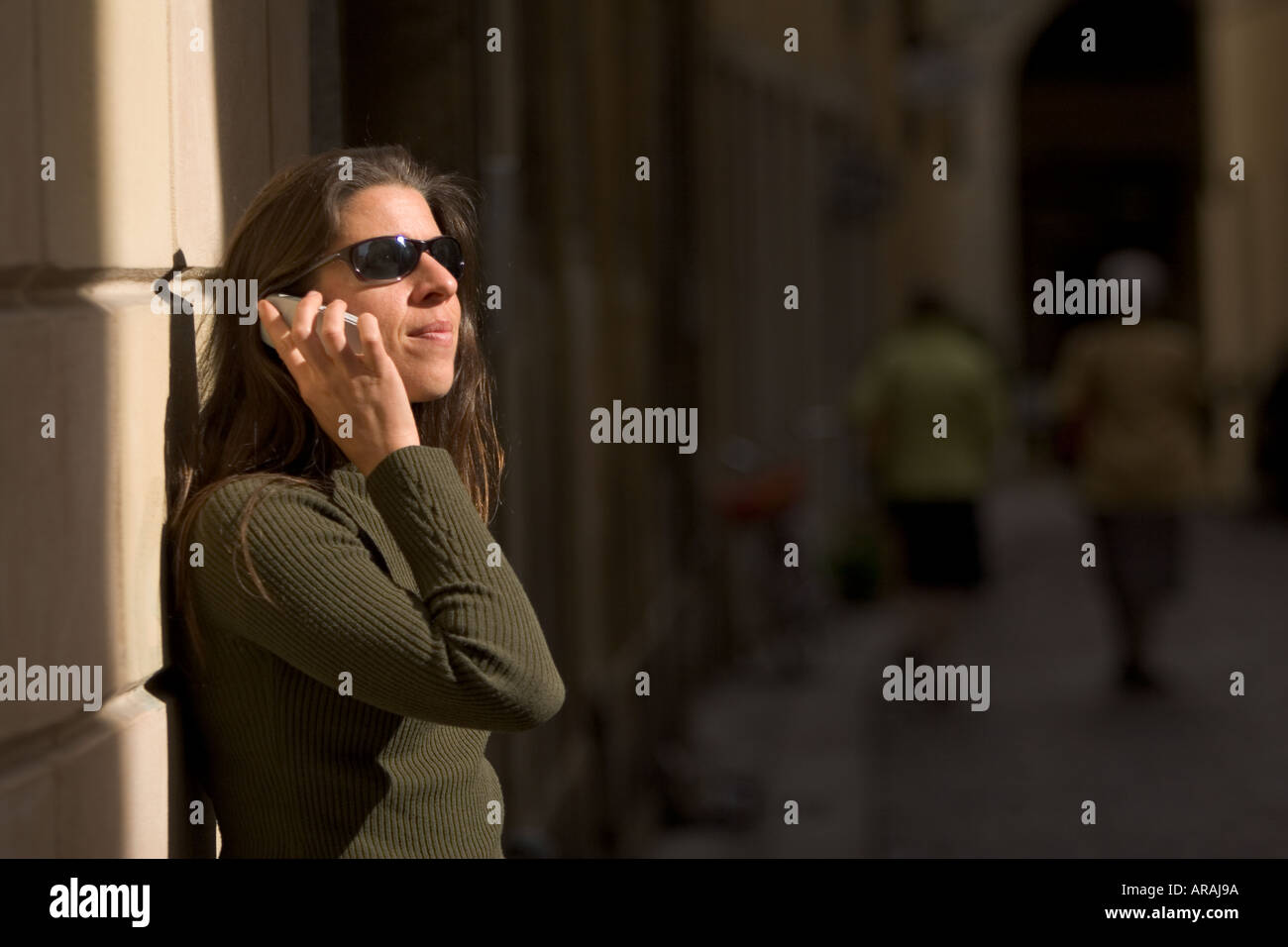 Young woman using a mobile in the streets of Vicenza Italy Stock Photo