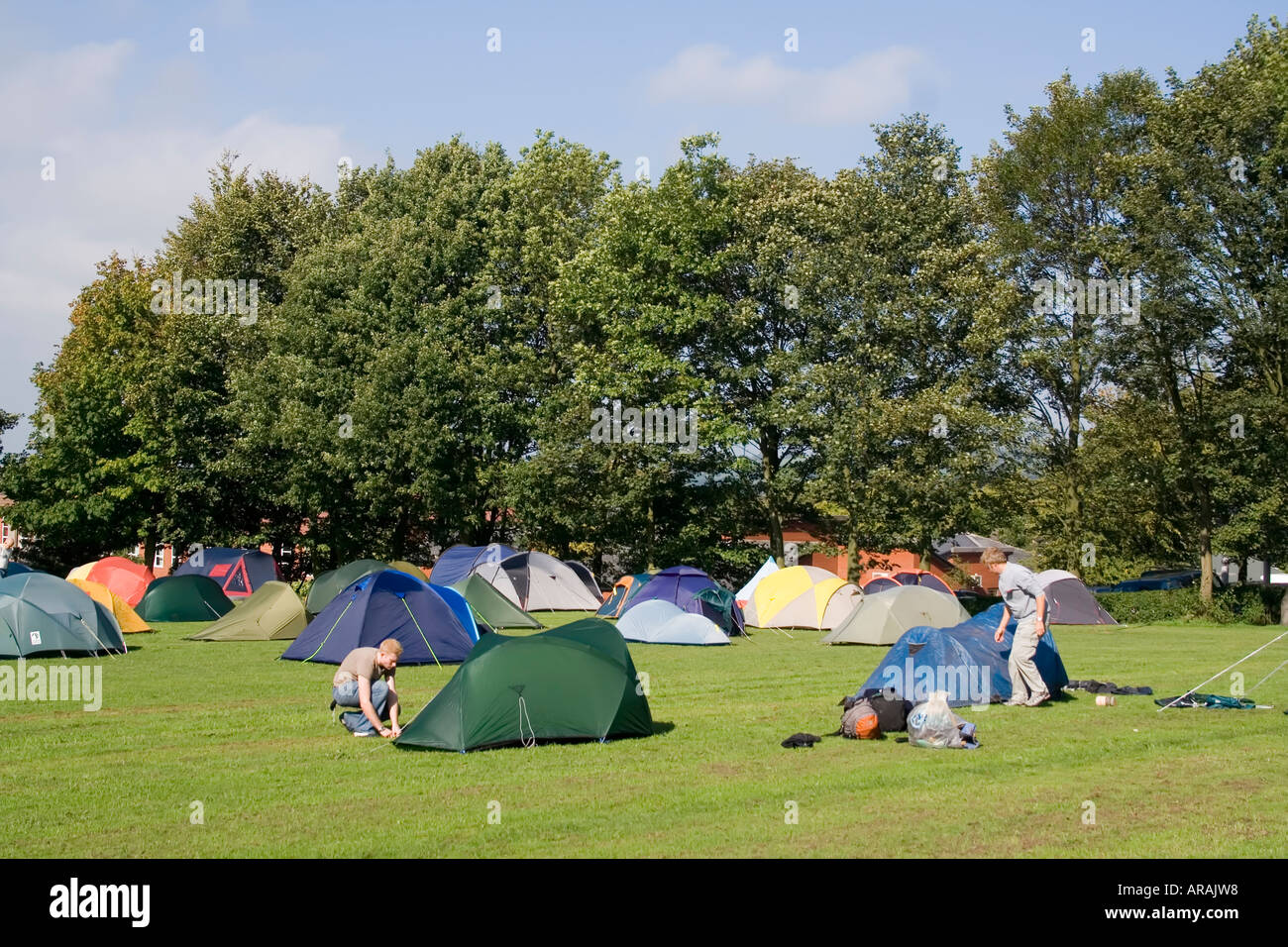 Erecting tents in a field Leek England UK Stock Photo