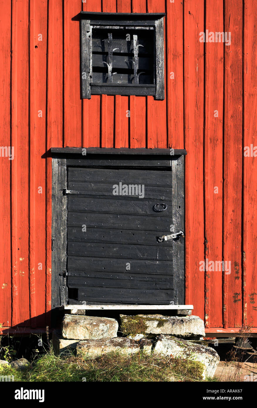 Old Black Barn Door Against Red Wall Panels Stock Photo 5221222