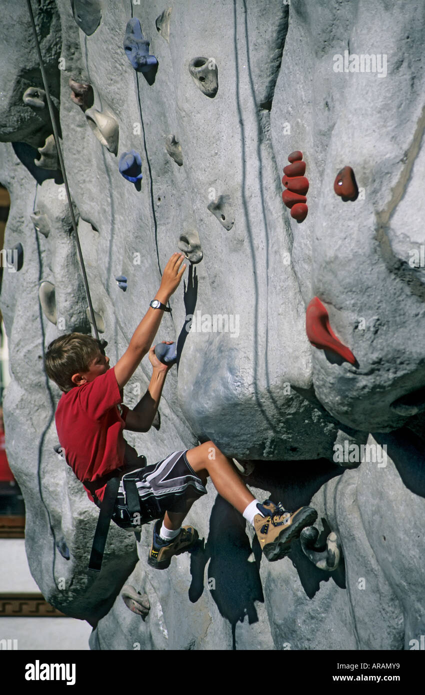 Boy on a rock climbing training pillar with artificial holds Mammoth Mountain Resort area Mammoth Lakes California USA Stock Photo