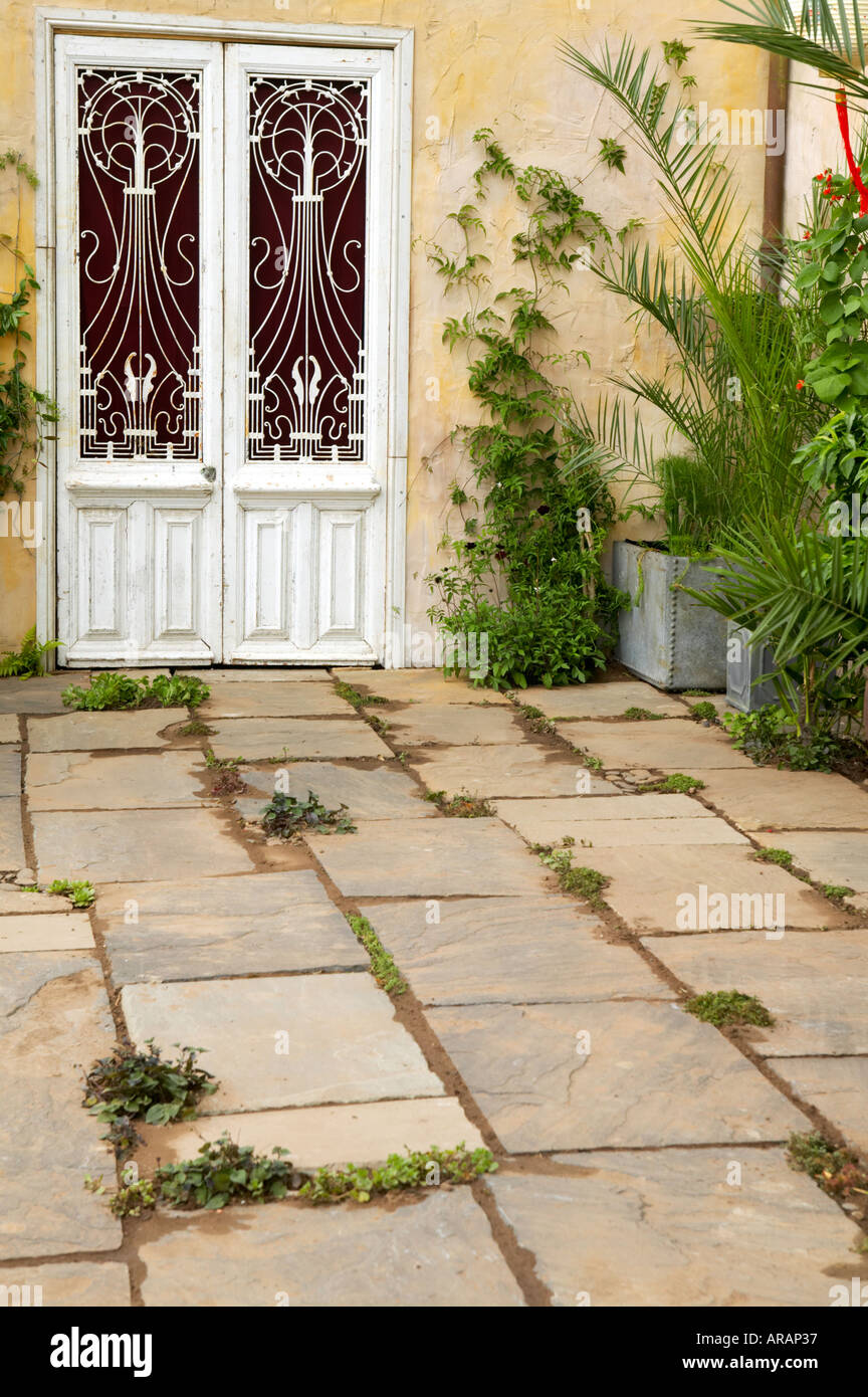 Tatton Flower Show Stone Patio With Iron Garden Furniture In