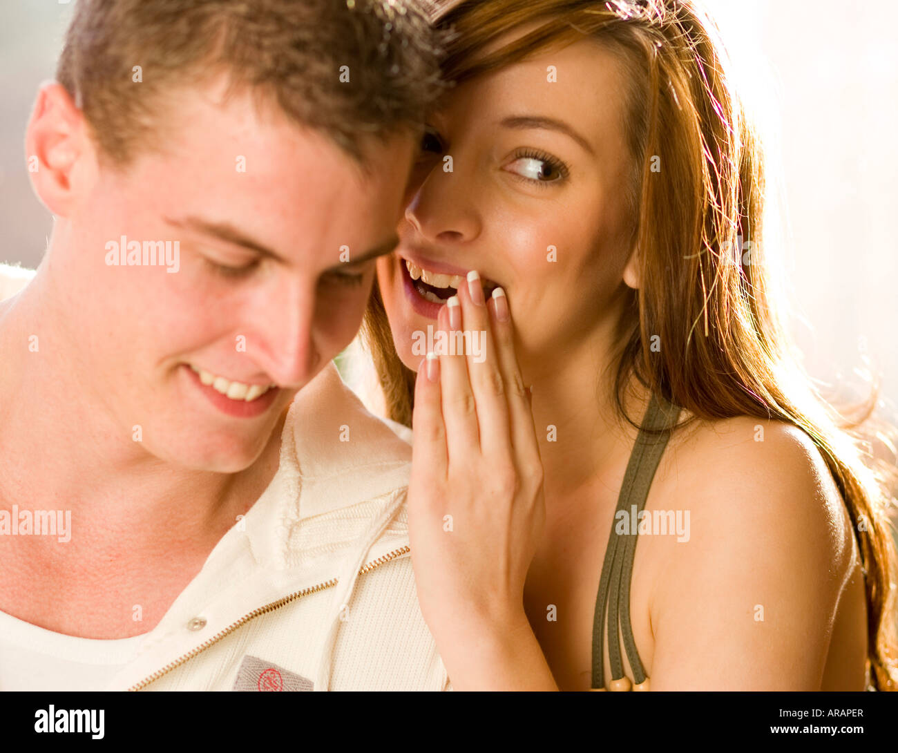 Couple whispering Stock Photo