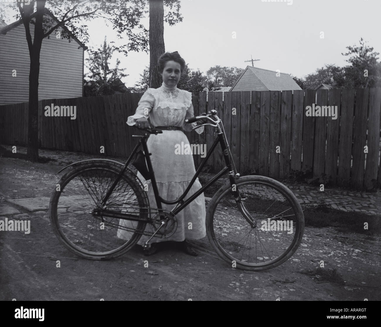 Victorian woman with bicycle. Circa 1900-1910. Location: USA, Unknown. Glass Negative. Stock Photo