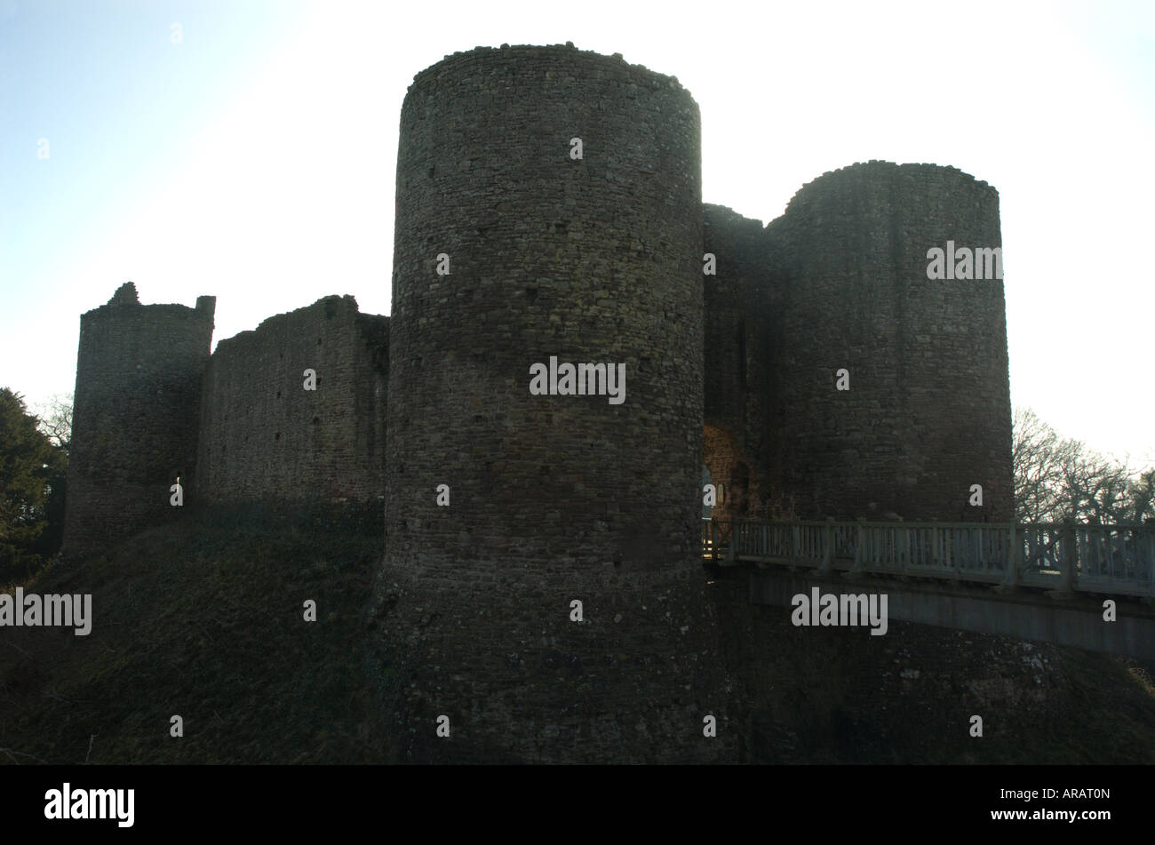 Imposing inner gate house, towers drawbridge and walls of ruined castle Stock Photo