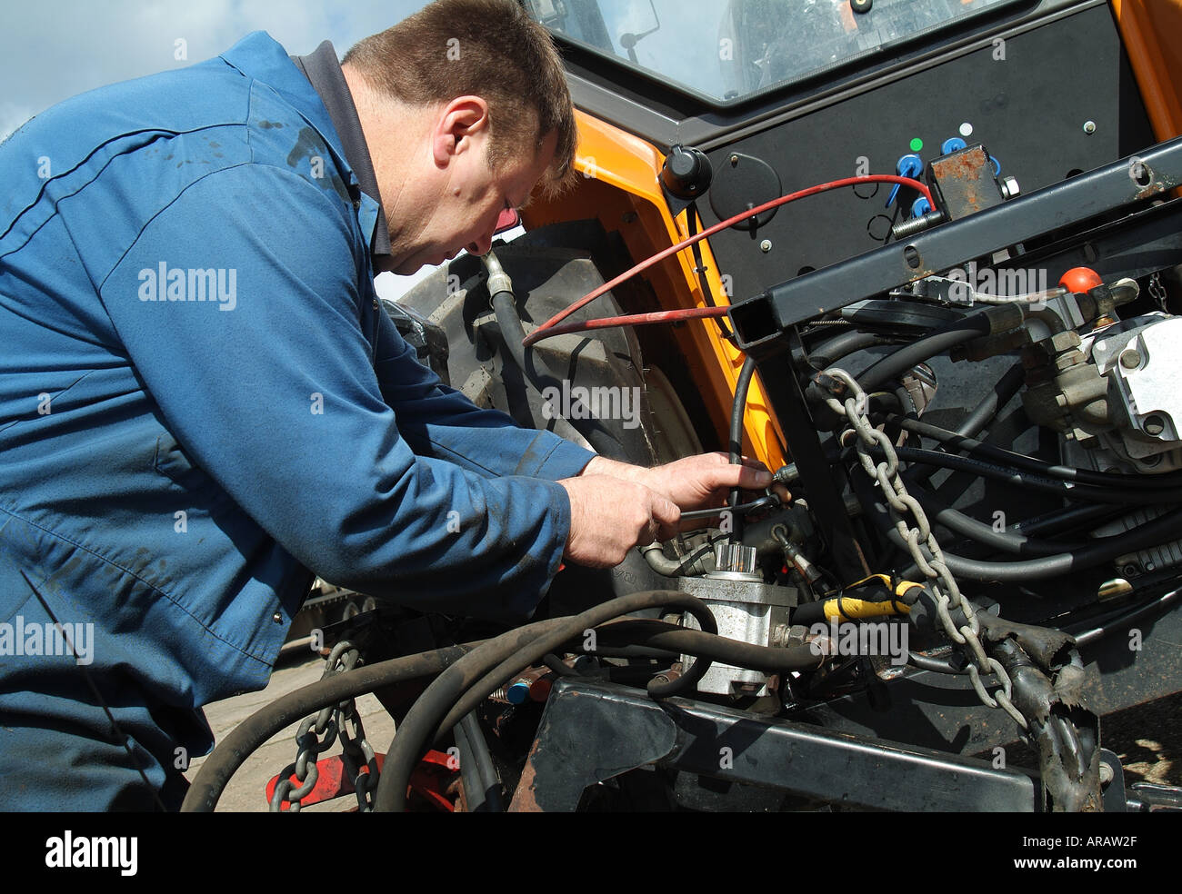 farm worker repairing tractor Stock Photo 5222702 Alamy